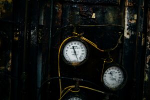 Close-up of old rusty pressure gauges in an industrial environment, showcasing decay and vintage charm.