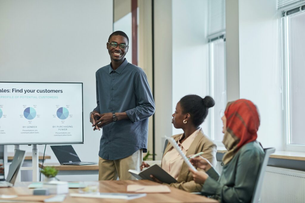 Positive and diverse team in a modern office discussing market analytics during a business meeting.